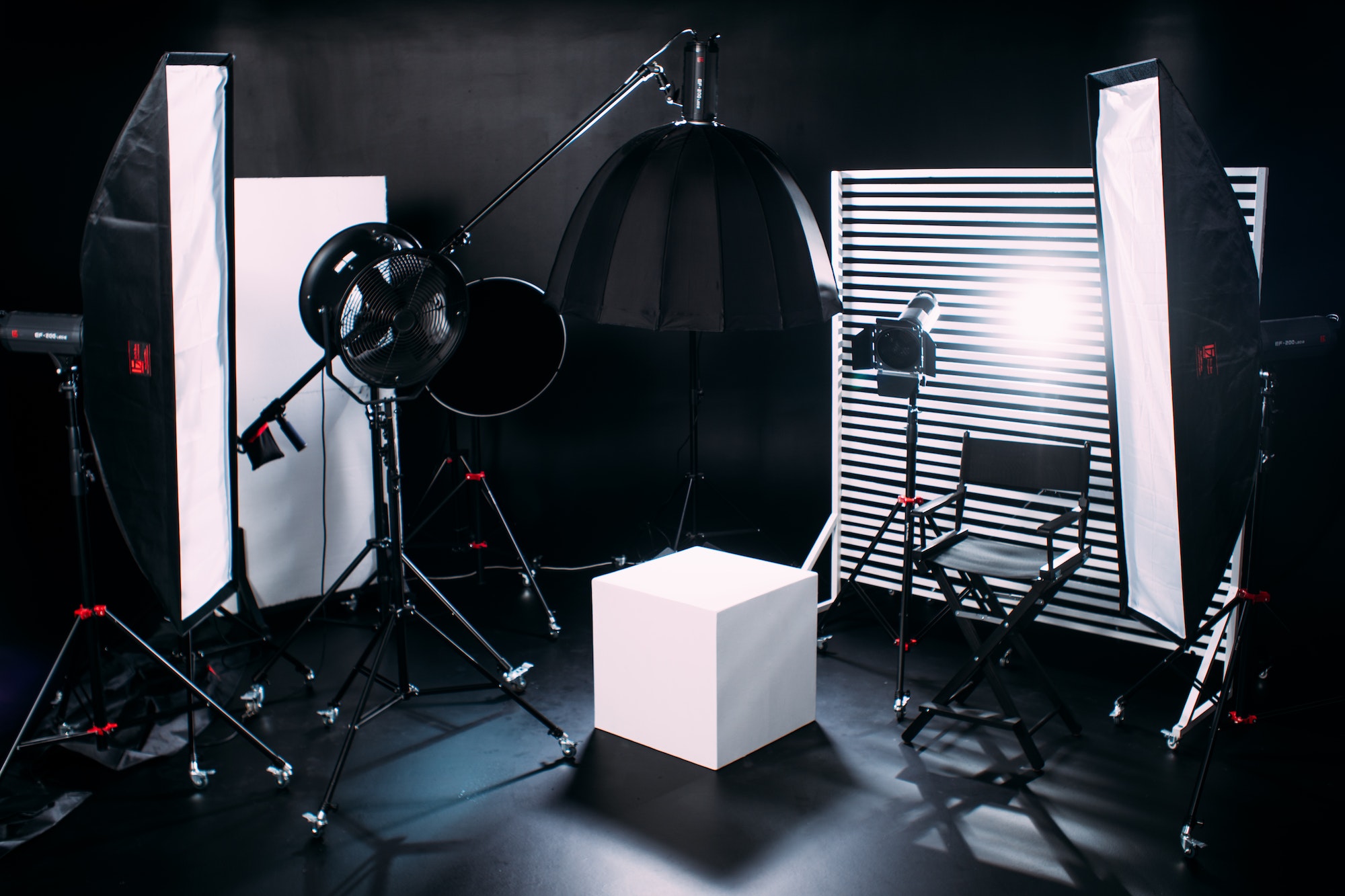 Modern photo studio with professional equipment. Black cyclorama.